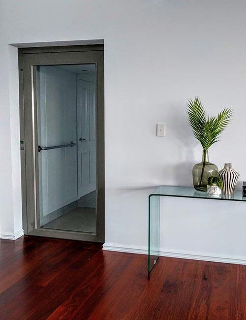 Closed glass doors of a residential lift in Melville