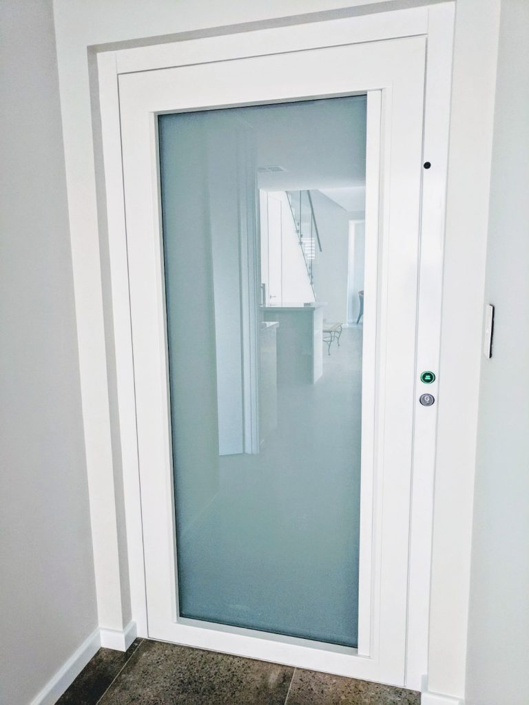 white residential lift with closed door