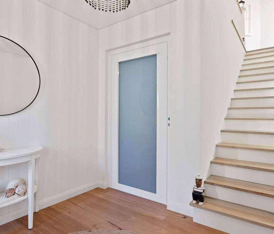 Blue glass door of a residential lift in Watermans Bay