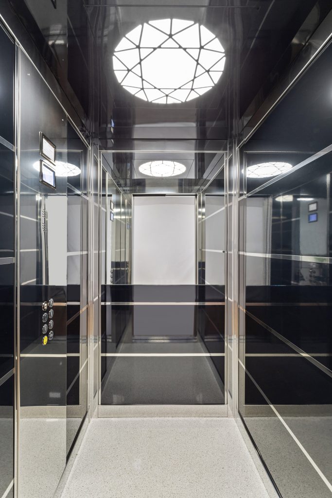 inside a sovereign home lift with mirrored skinplates and designer lighting