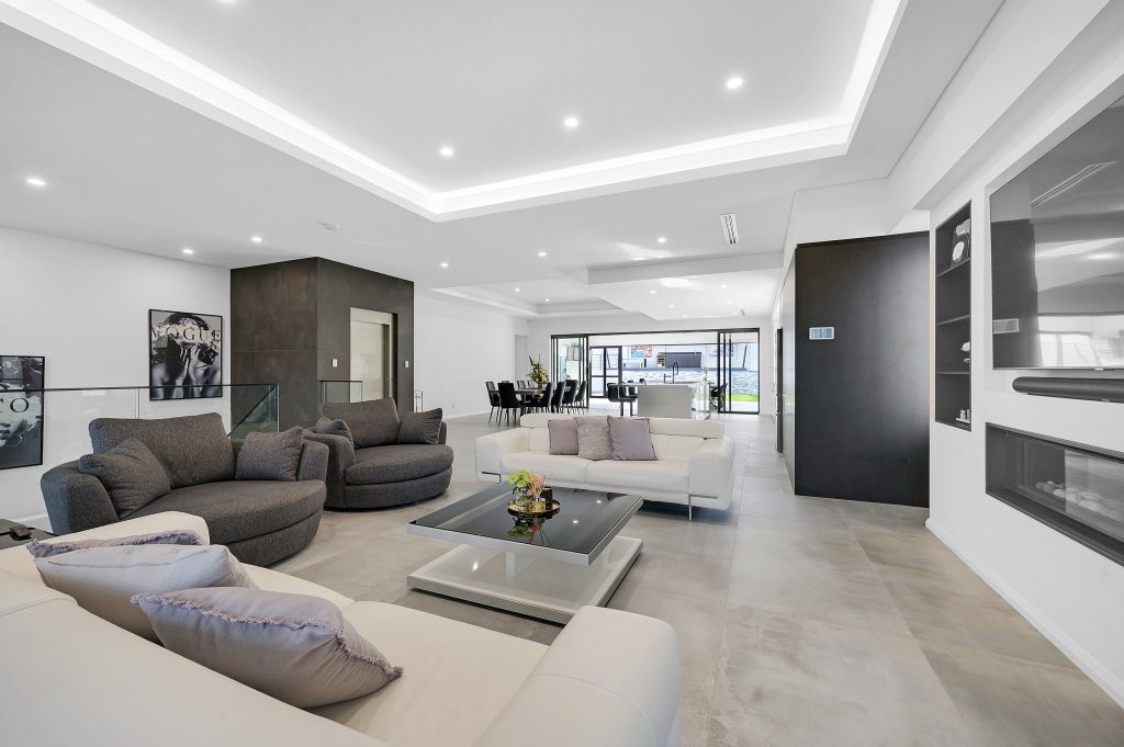 zoomed out photo of a luxurious dining area featuring a dark coloured lift