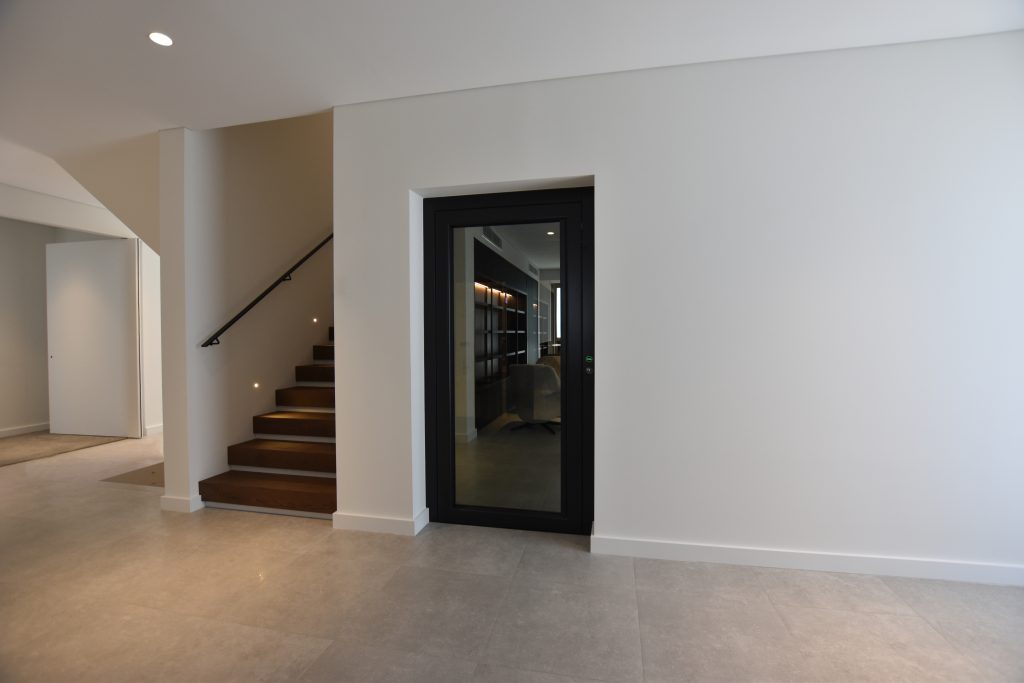 a closed door elevator next to a staircase.