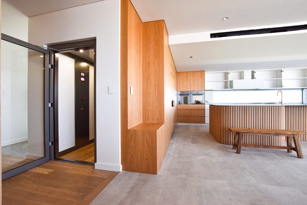 a modern living room and kitchen with a luxury lift.