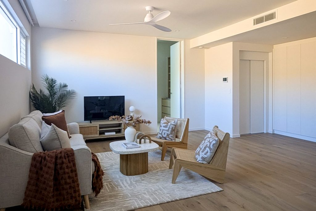 Modern living room with TV and wooden furniture.
