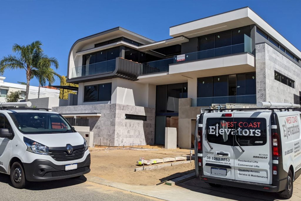 West Coast Elevators trucks at modern building site.