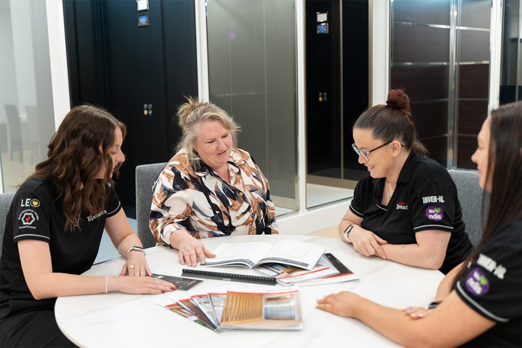 Group of women discussing design plans in office.