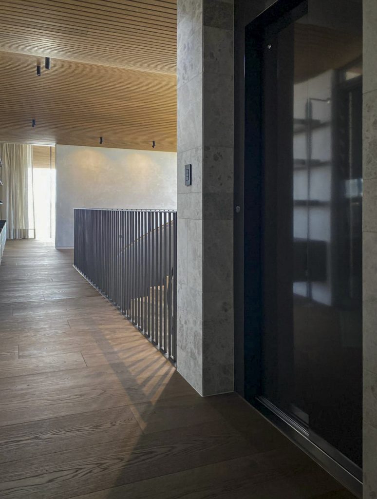 Modern hallway with wooden floors and ceiling