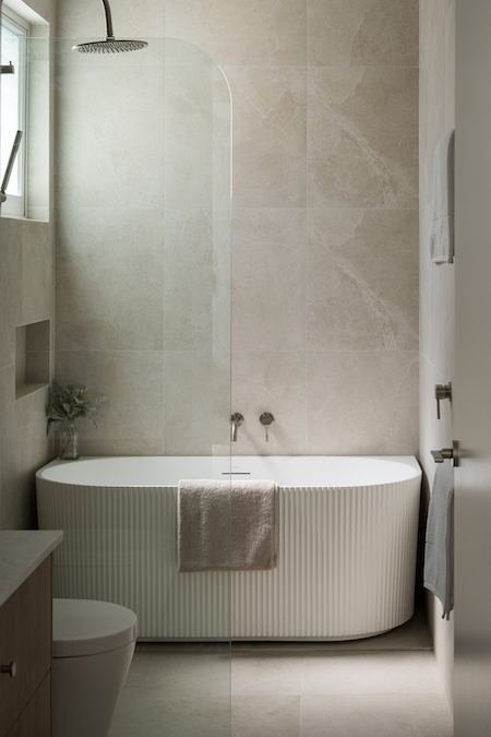 Modern bathroom with bathtub and glass shower.