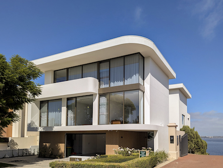 Modern beachfront house with clear blue sky.