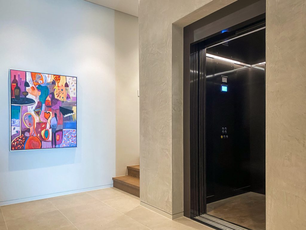 Modern hallway with elevator and colourful abstract painting