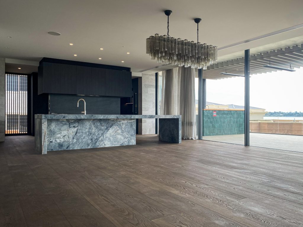 Modern kitchen with marble island and chandelier