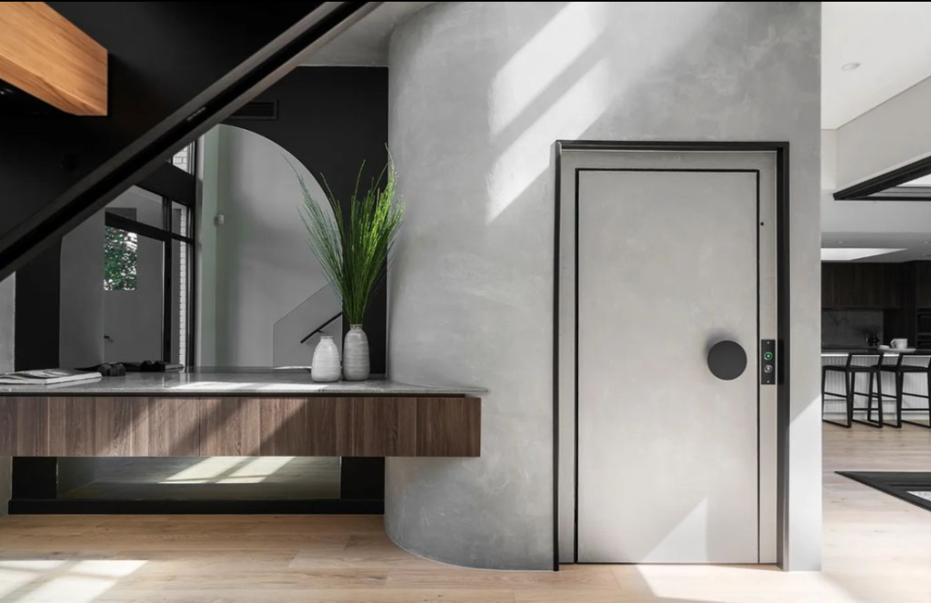 Modern home lift beside wooden console table