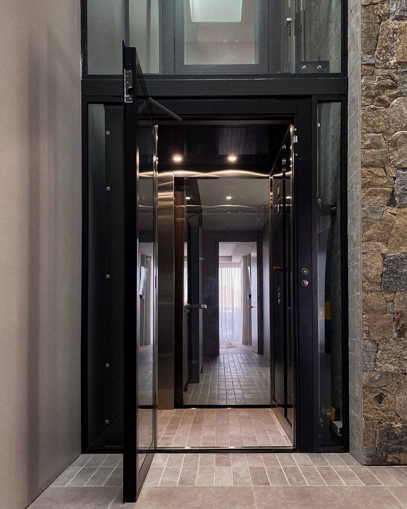 Modern glass home lift with open door