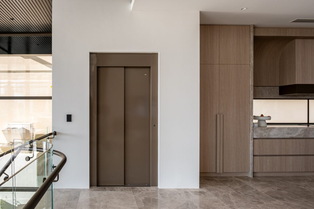 Modern home interior with elevator and timber cabinetry