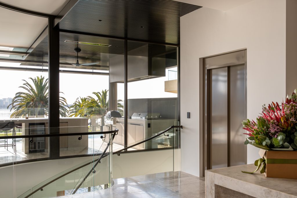Modern home interior with balcony and waterfront view