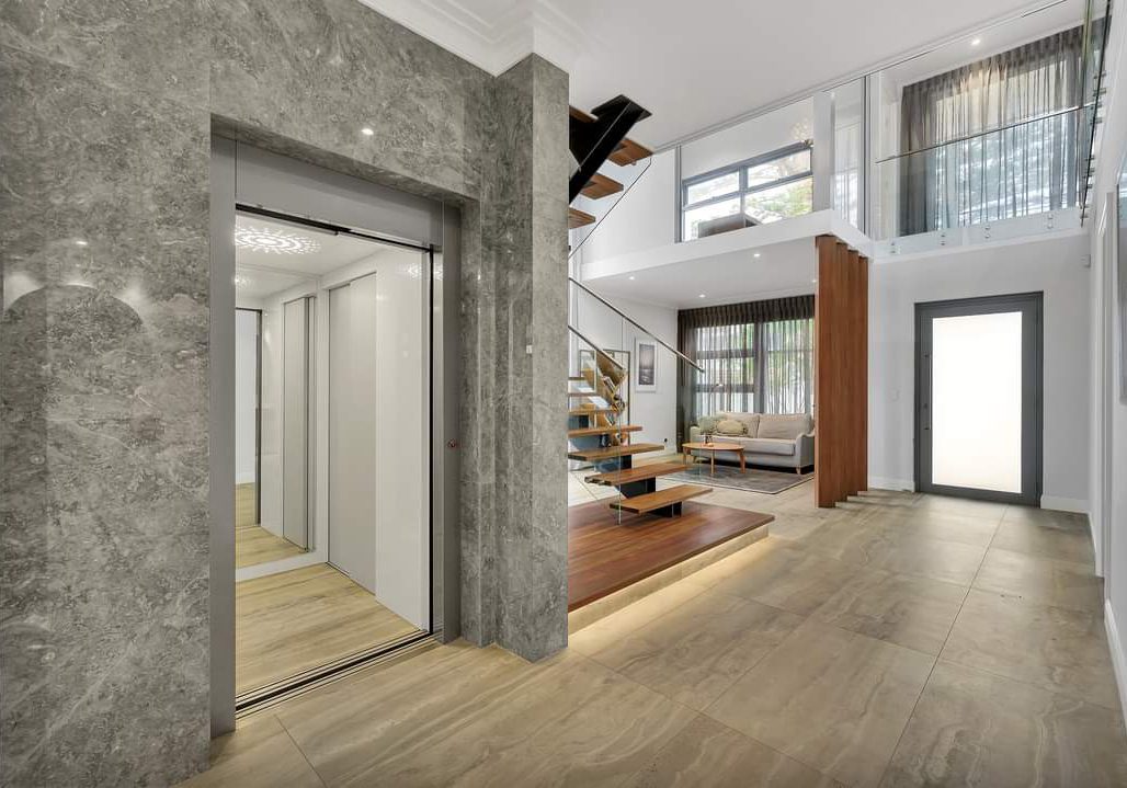 Modern home interior with open staircase and elevator.