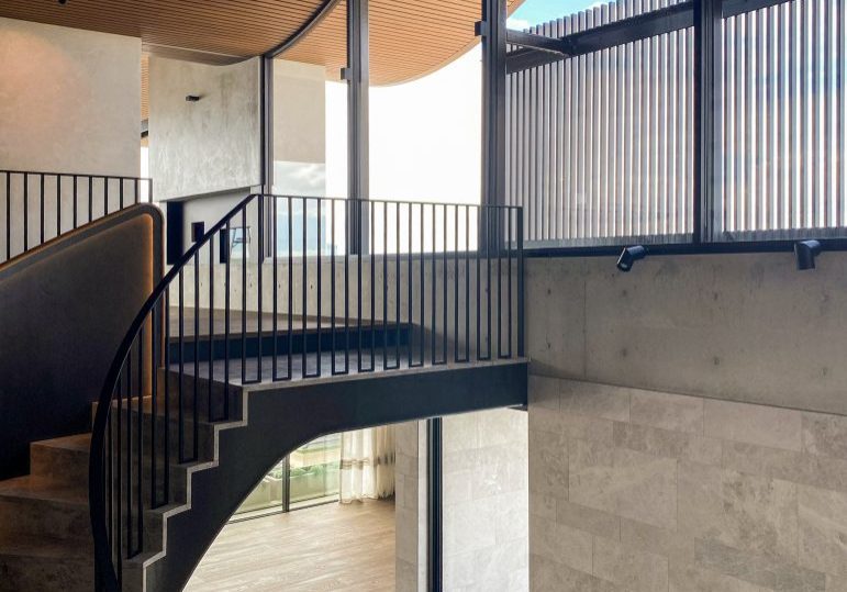 Modern interior with curved staircase and large windows