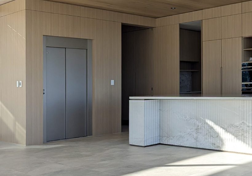 Modern minimalist kitchen with marble island and wood panels
