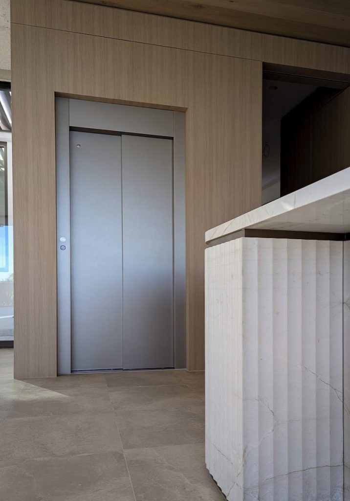 Modern lift with timber wall and stone counter