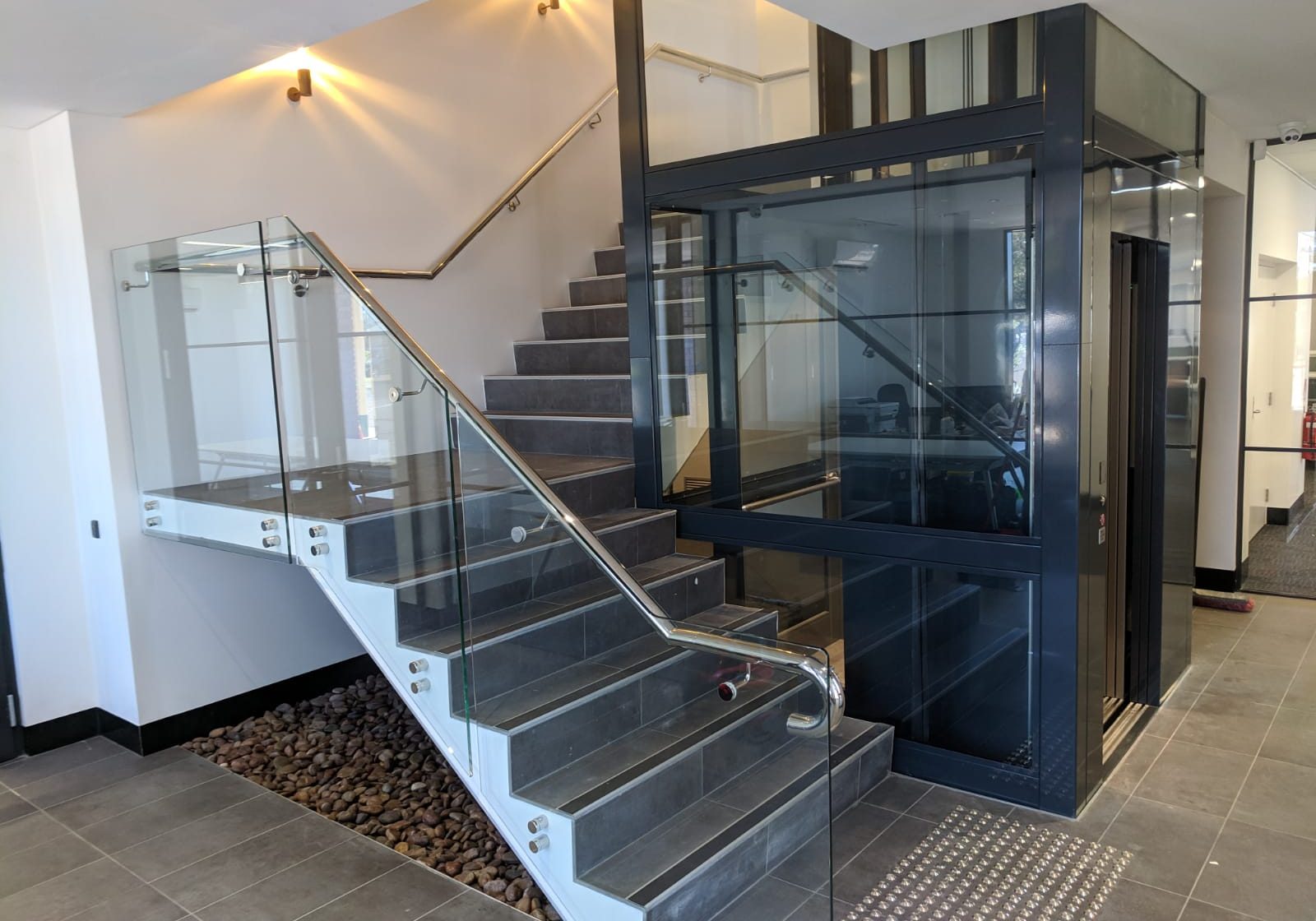 Katanning commercial lift with stairs wrapping around it