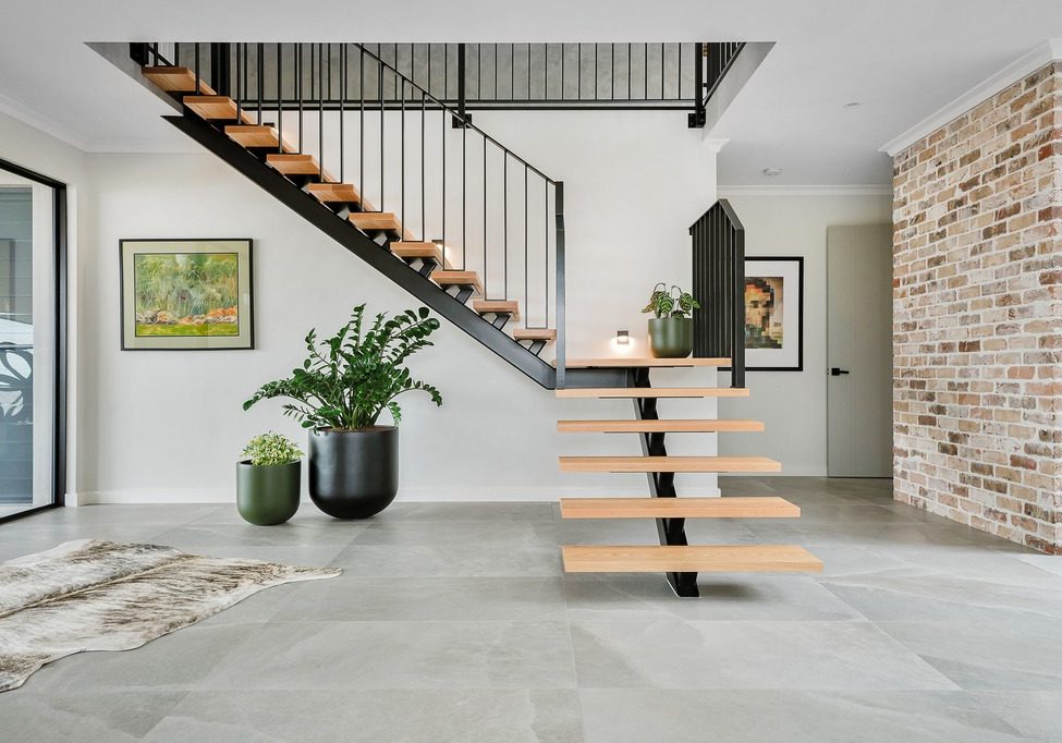 Modern floating staircase with brick feature wall