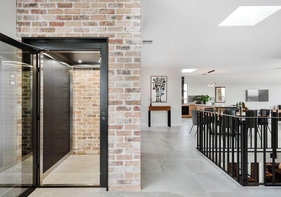 Modern home interior with brick wall and lift