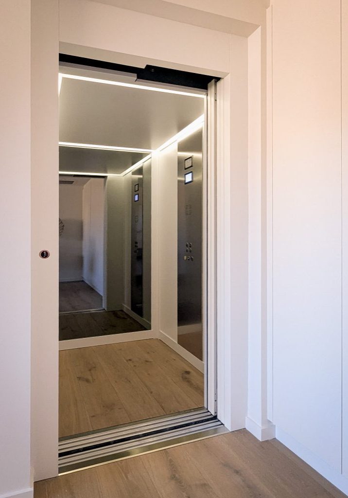 Modern home lift with mirrored interior and LED lighting