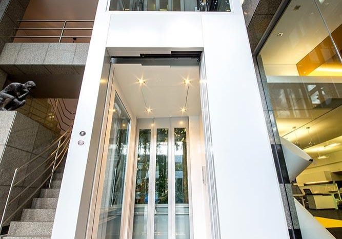 White commercial lift with glass features