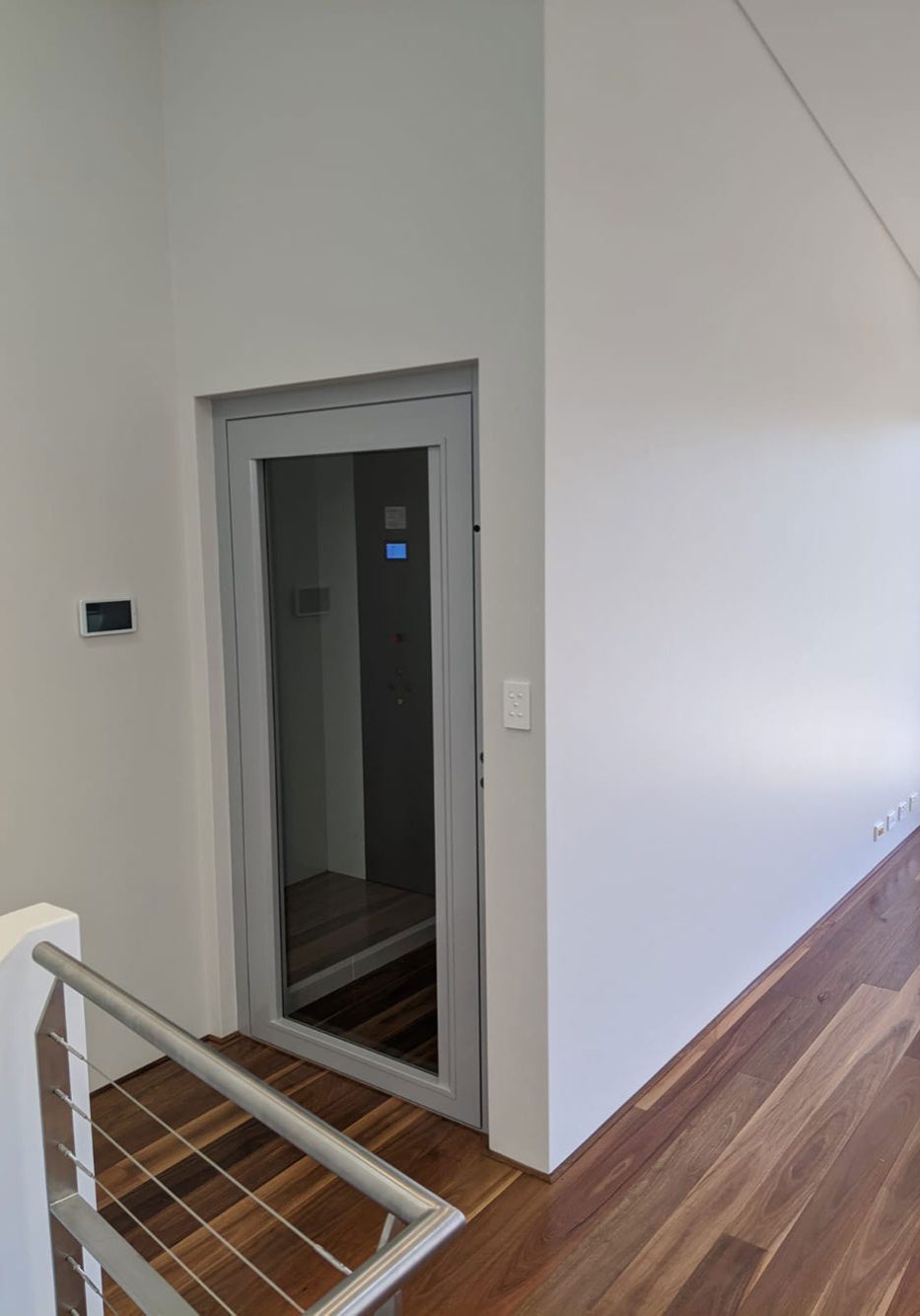A stylish glass door lift installed in a residential Shelly home