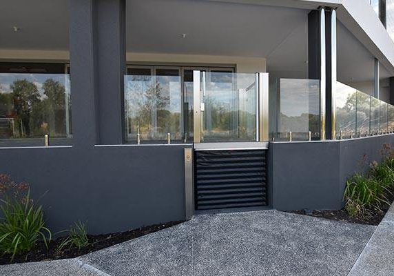 DDA Compliant mini lift with a dark design and glass feature