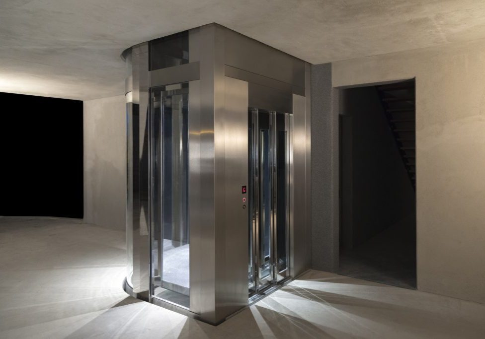glass and stainless steel jewel home lift installed in new build