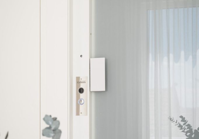 Modern home elevator with glass door and call button