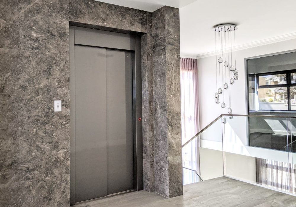 royal elevator design installed in marble feature wall