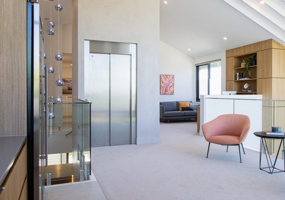 minimalist stainless steel home lift installed in upper living area