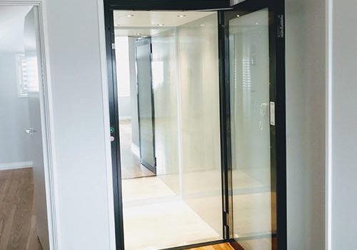 Open door of a South Perth residential lift with glass door and black finishing. Supplied and installed by West Coast Elevators